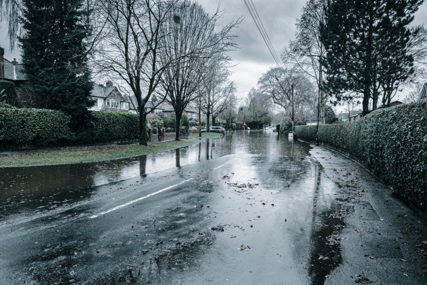 Flooded street in residential area on a rainy day.