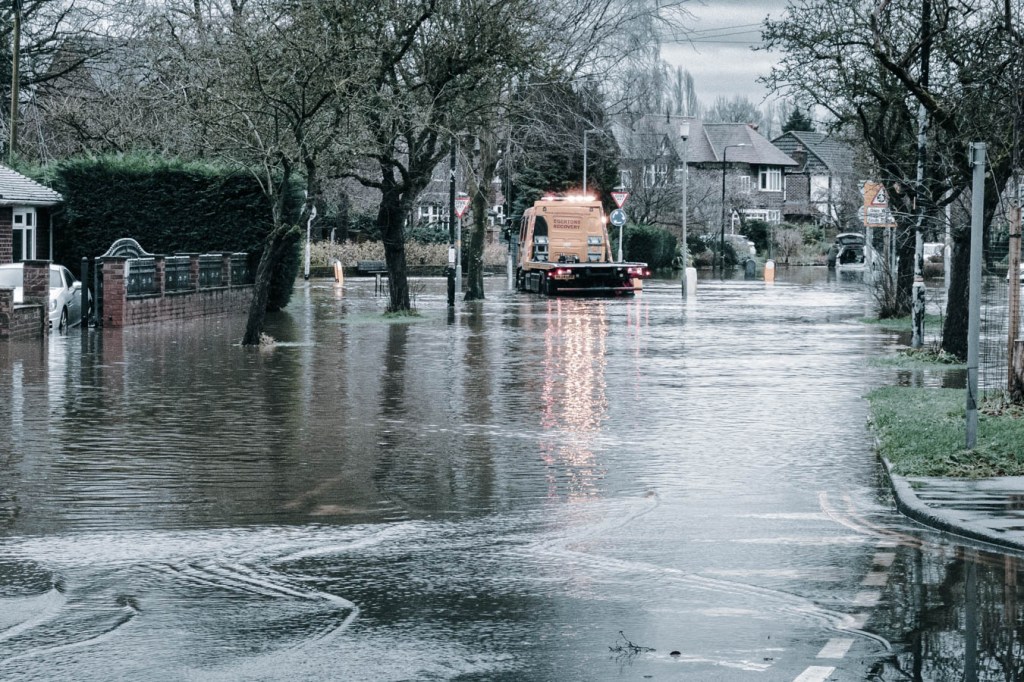 Flooded street in residential area on a rainy day.