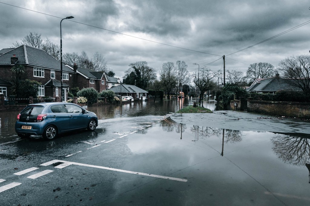 Flooded street in residential area on a rainy day.