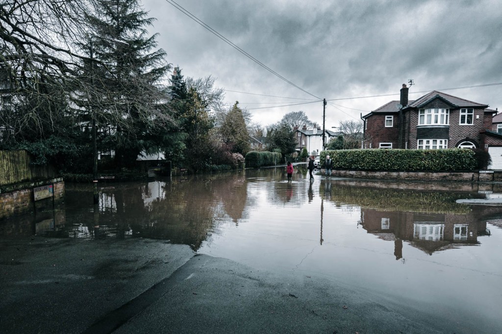 Flooded street in residential area on a rainy day.