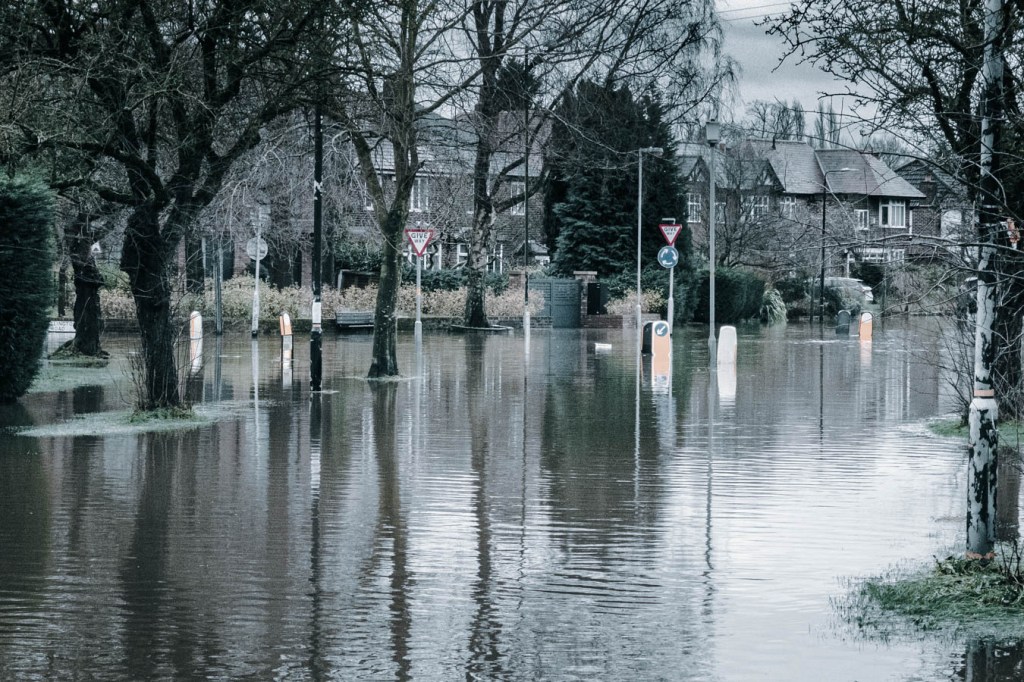 Flooded street in residential area on a rainy day.